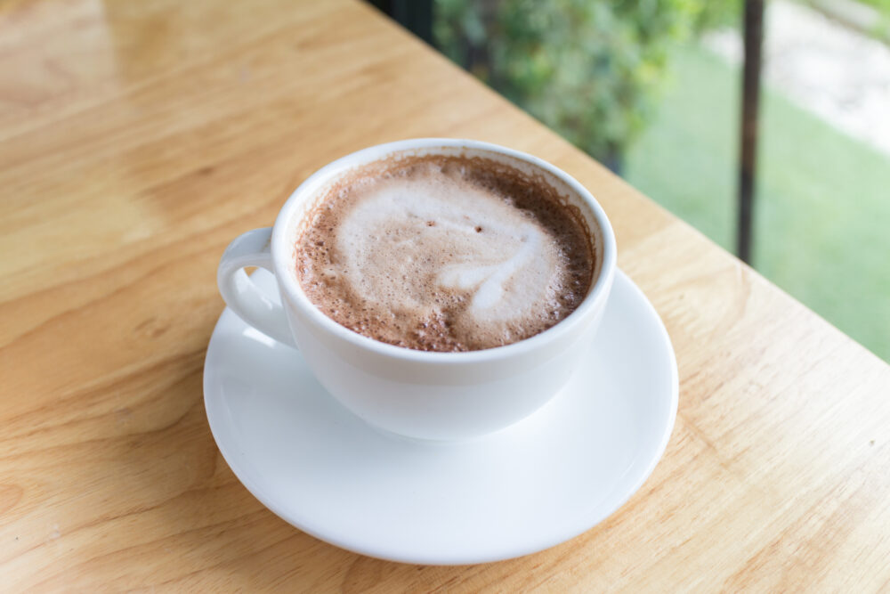 hot coffee mocha with foam milk in countryside cafe